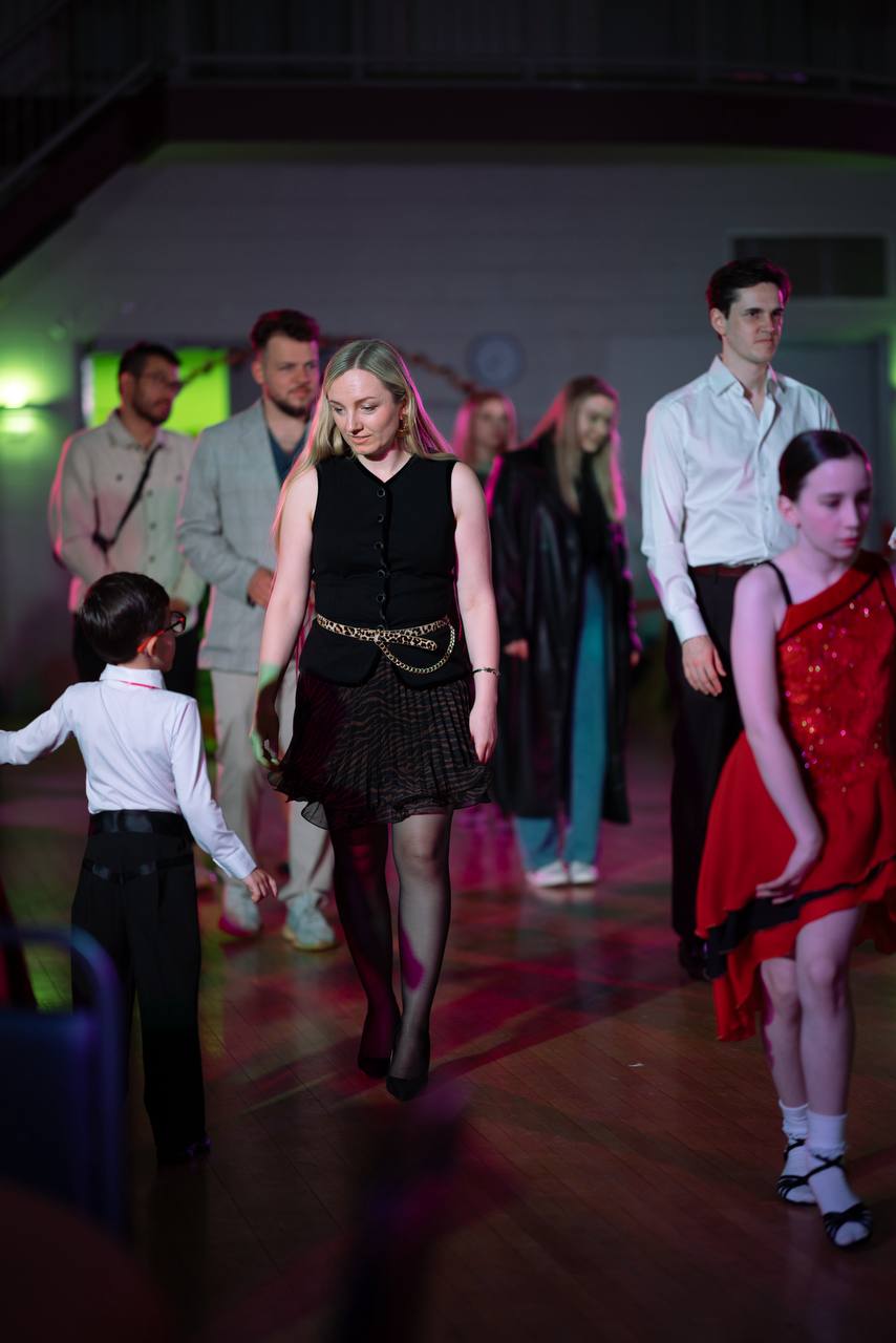 Students and adults taking part in a community dance