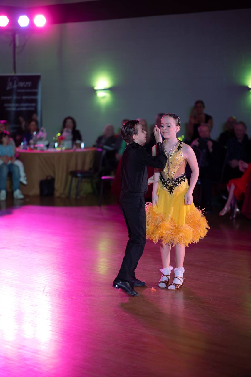 Young dance partners celebrating the end of their performance