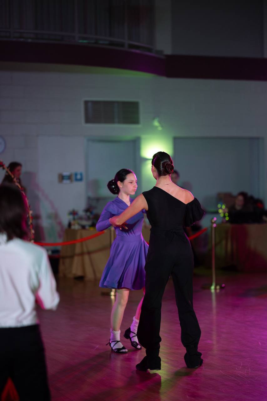 Young ballroom dancer performing in purple
